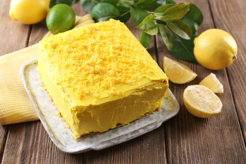 Tasty lemon cake on wooden table