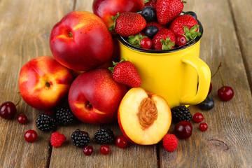 Naklejka na ściany i meble Peaches and berries on table close-up