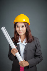 Asian engineer girl hold a blueprint and smile