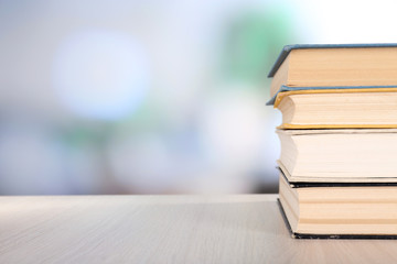 Books on wooden table on natural background