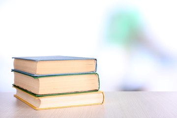 Books on wooden table on natural background