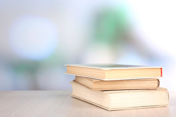 Books on wooden table on natural background