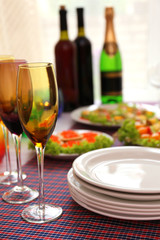 Buffet table with dishware waiting for guests