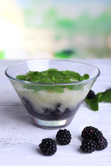 Melon smoothie in glass bowl on table on bright background