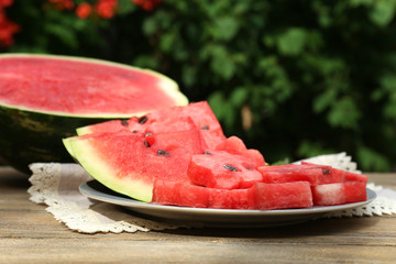 Fresh slices of watermelon on table, outdoors