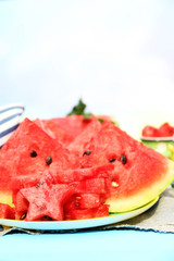Fresh slices of watermelon on table, on bright background