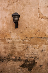 Vintage lamp on old plaster walls.