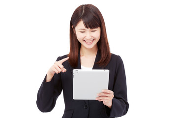 Fototapeta premium タブレットを持って操作するビジネスウーマン