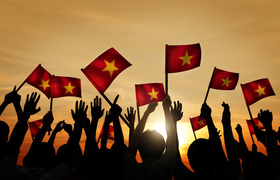 Group of People Waving Vietnamese Flags