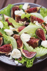 Salad with sliced figs, mozzarella and walnuts, close-up
