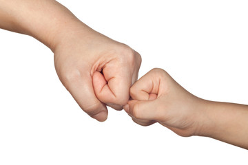 Closeup of a fist bump between an adult and a child isolated