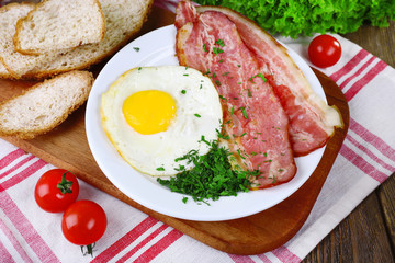 Scrambled eggs with bacon and vegetables served