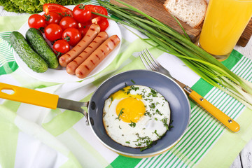 Scrambled egg with sausage and vegetables served