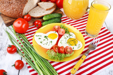 Scrambled eggs with vegetables and juice served in plate