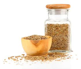 Square glass bottle and wooden round bowl with seasoning