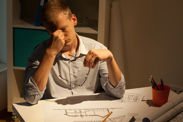 Tired architect at night