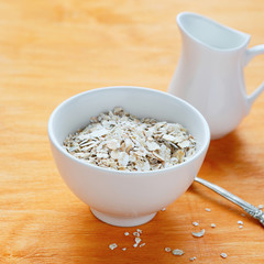 flakes in a white bowl and jug