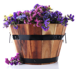 Big wooden basket with fresh flowers isolated on white