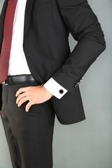 Man in black suit on grey background