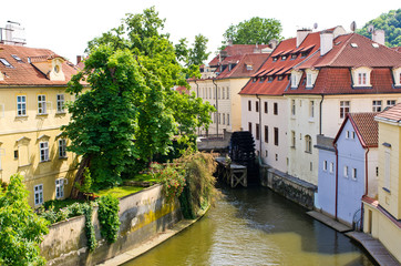 Fototapeta na wymiar Water Mill on Vltava river in Prague, Czech Republic