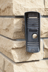 Door bell on brick wall