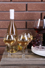 Bottles and glasses of wine and ripe grapes