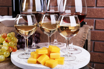 Bottles and glasses of wine, cheese and ripe grapes