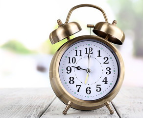 Alarm clock with sticker on bright background