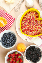 Baking tasty pie and ingredients for it on table in kitchen