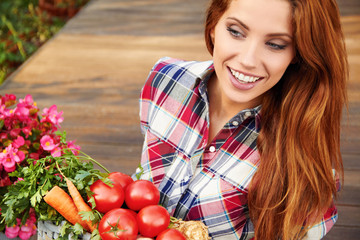 beautiful woman with vegetables in the garden
