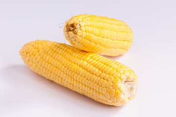 Grains of ripe corn on white.