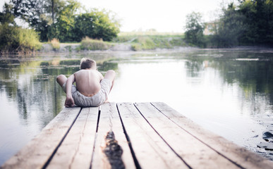 Boy sitting at the lake