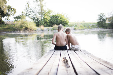 Children on a dock at a lake