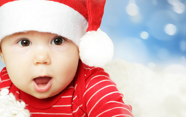 Surprised baby in Santa hat having fun, Christmas and Happy New