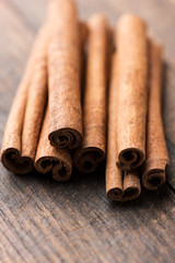 Cinnamon sticks on rustic wooden background macro