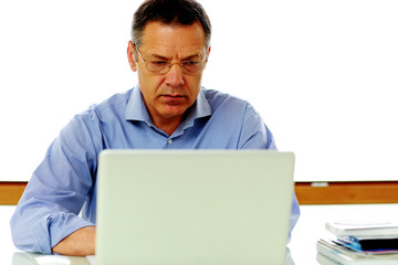 Portrait of senior caucasian man working on his laptop computer.