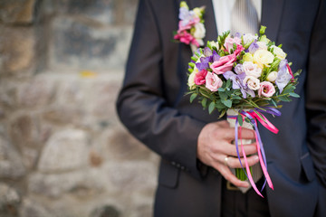 Groom with wedding bouquet