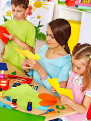 Children with teacher at classroom.