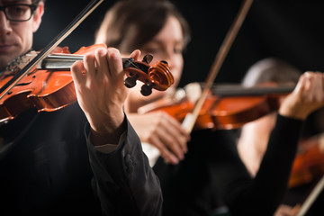 Violin orchestra performing on stage © stokkete