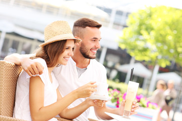 Happy couple drinking coffee in a cafe