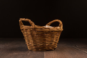 Wicker basket isolated on dark background