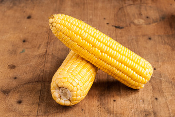 Grains of ripe corn on wood.