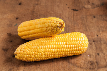 Grains of ripe corn on wood.