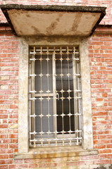 The closeup of window with iron bar grill