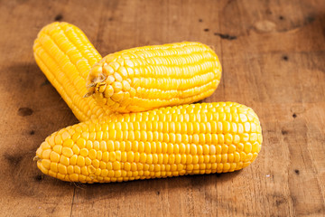 Grains of ripe corn on wood.