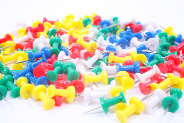 Colored pushpins isolated on white background