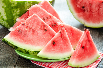 Ripe watermelons on table on the wooden background