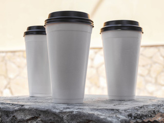 White disposable cups with black lids