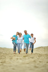 Grandparents with grandchildren on the beach