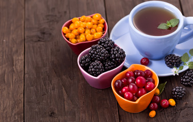 Various berries with cup of tea